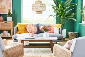 Living room with two chairs, a table, and a vase of flowers in front of a window. Spring best seasonal home decor trends focus on nature and pastels.